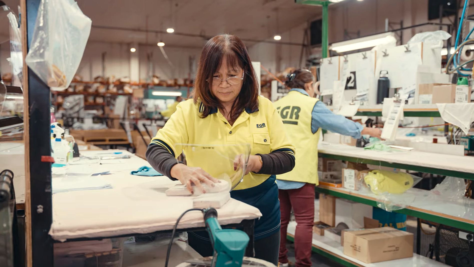 EGR team member sanding a component on the production floor